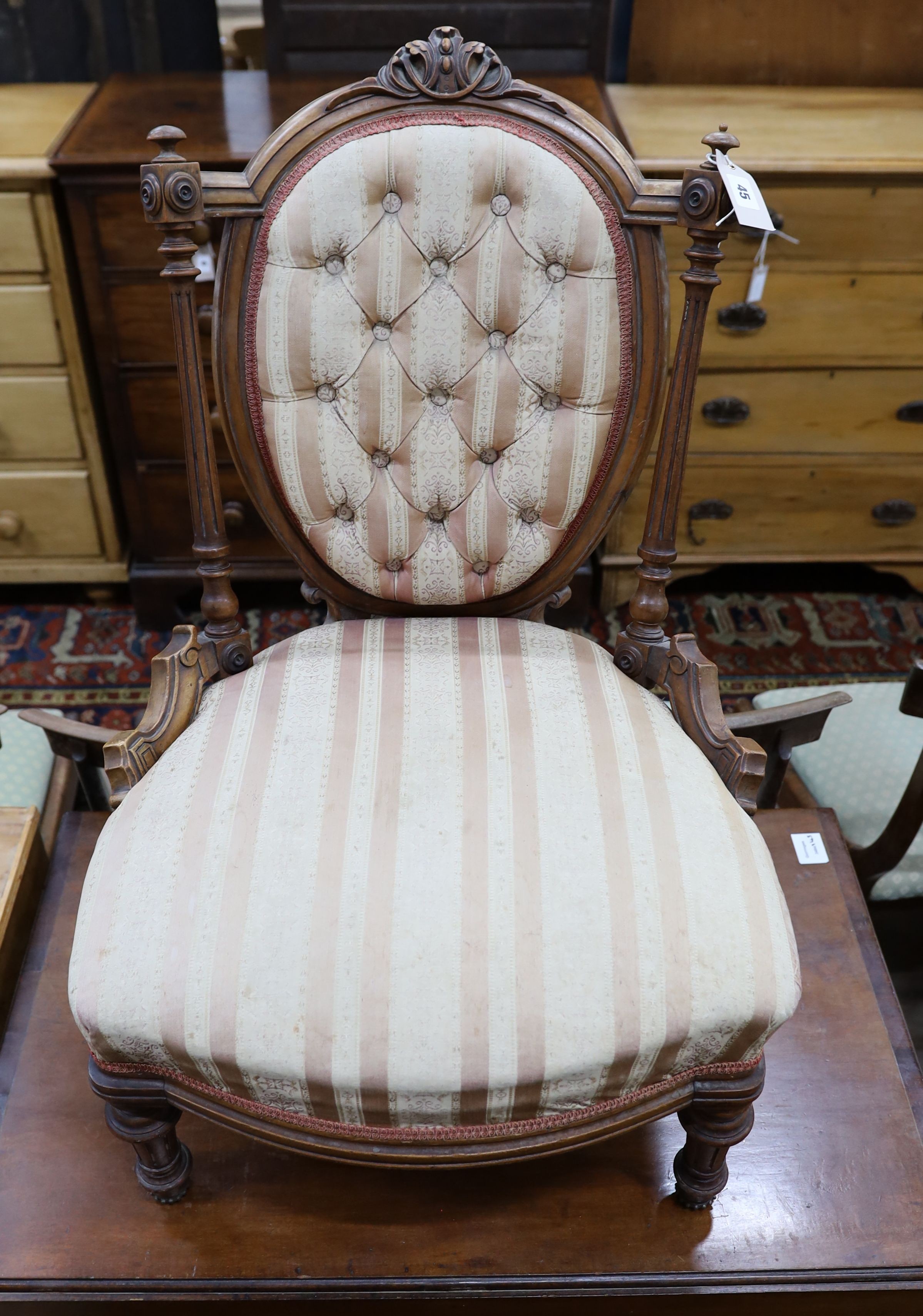 A small late Victorian carved walnut sewing chair, with buttoned back and turned legs, width 53cm, depth 50cm, height 80cm